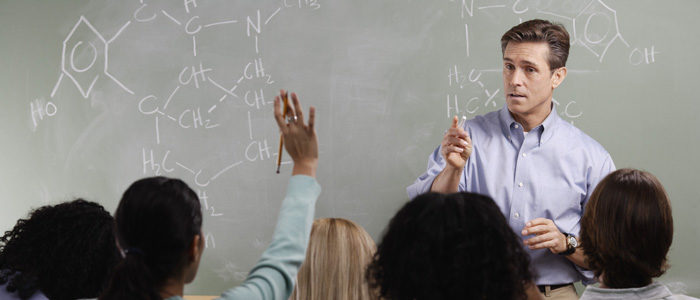 Chemistry Teacher with Students in Class --- Image by © Royalty-Free/Corbis